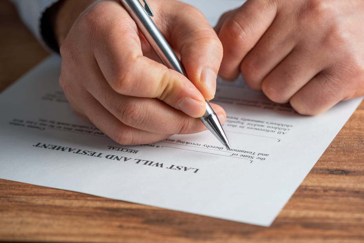 A concept of making a will - Man filling out his last will and testament.