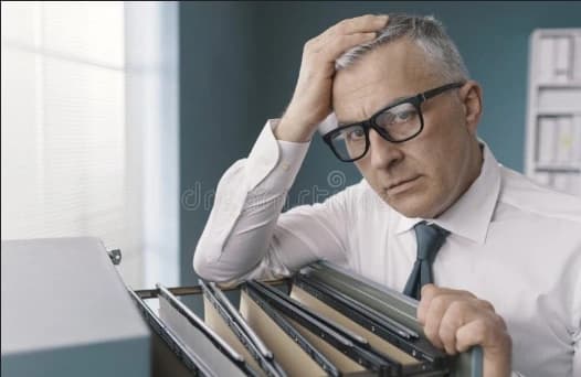 Man at file cabinet doing a will search