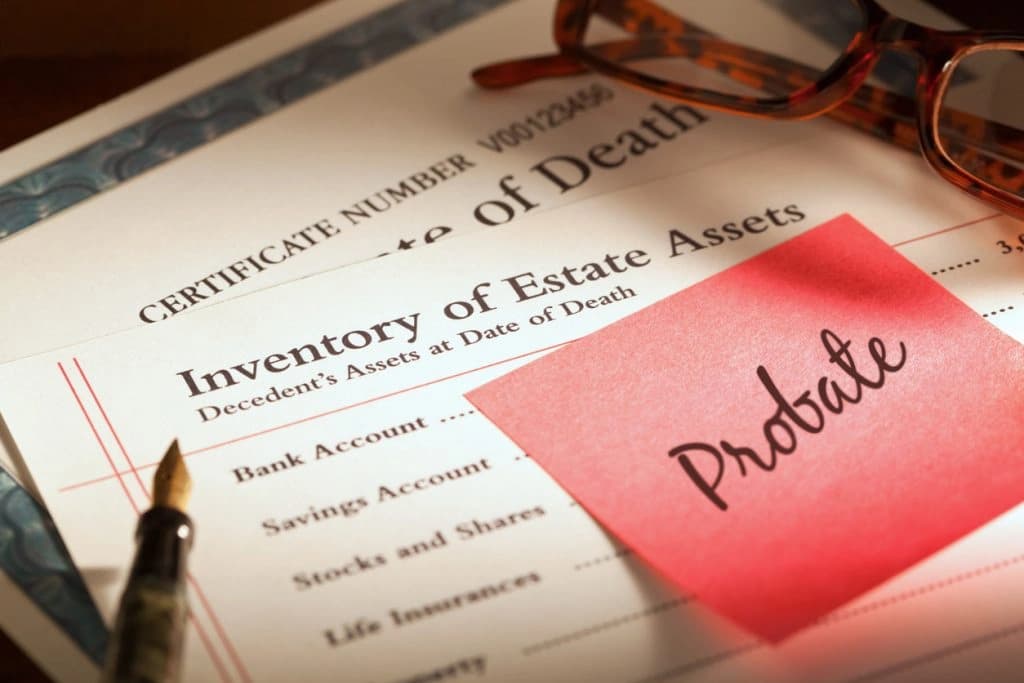 Probate-without-a-will A concept of filing probate without a will - probate application form and estate documents on a table.
