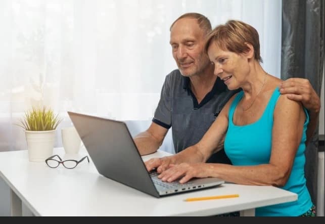 Couple-writing-a-free-online-will-program Couple using a free online will program together on a laptop at home.