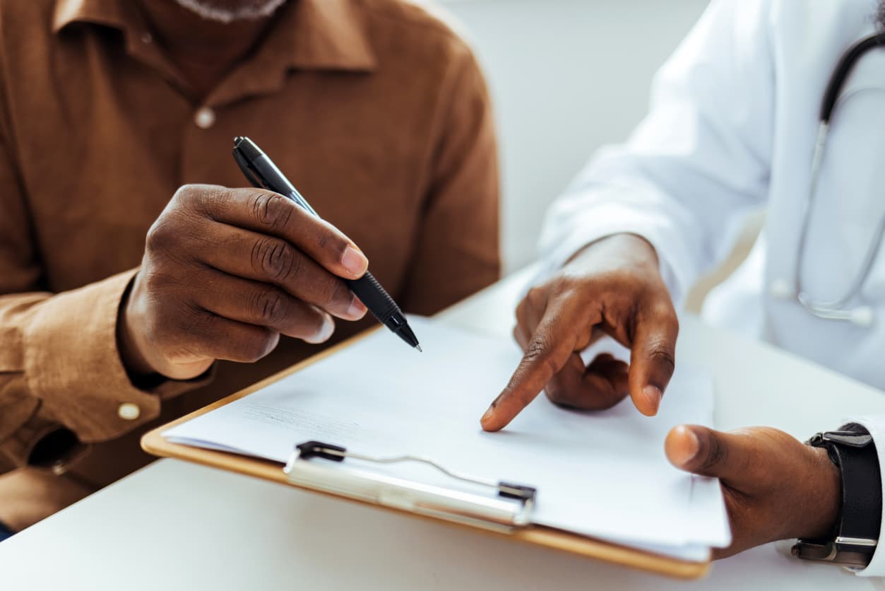 Making decisions about your own healthcare. Senior man speaking to his doctor about creating a living will.