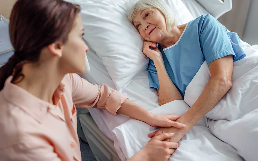 Planning-for-Death Planning for Death: Steps to take. Depicted by a family gathered around an elderly man in a hospital bed