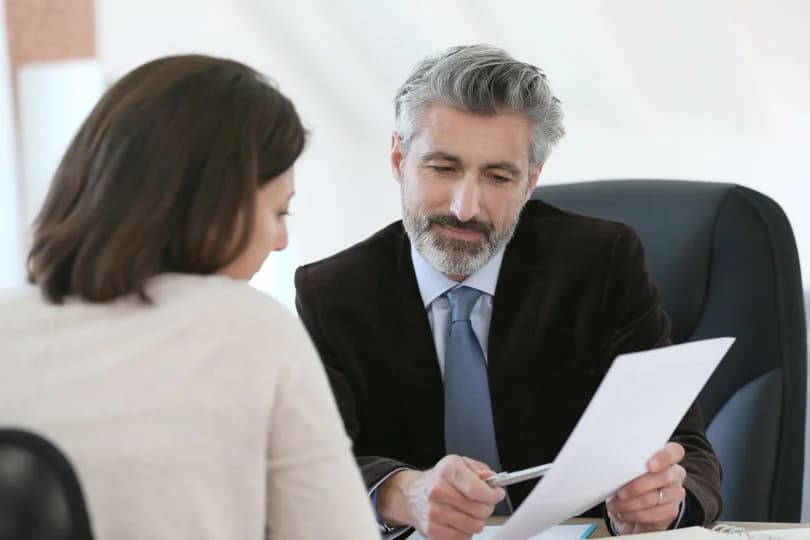 Consulting-with-Administrator-of-Estate Man showing woman a document