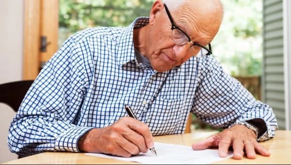 Man-writing-distribution-of-estate-letter-to-beneficiaries Distribution of Estate Letter