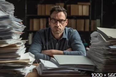 Executor of estate overwhelmed Man at desk managing documents as executor of estate responsibilities