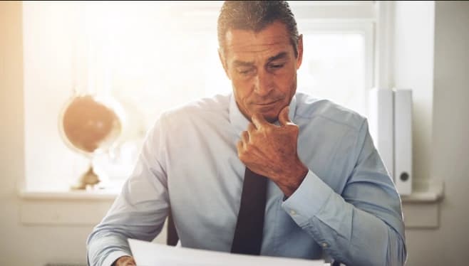 Settling an estate without a will or legal heir (1) Man at desk settling an estate without a will or legal heir